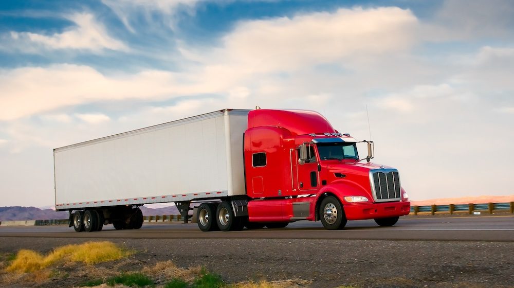 Red truck moving on a highway